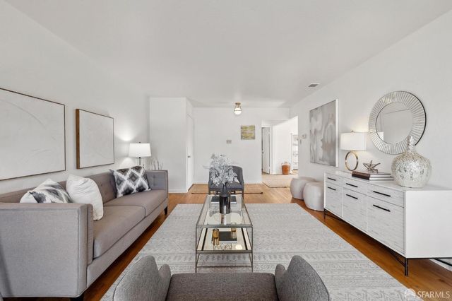 a living room with furniture white walls and white walls