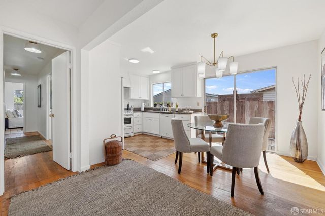 a dining room with furniture and wooden floor