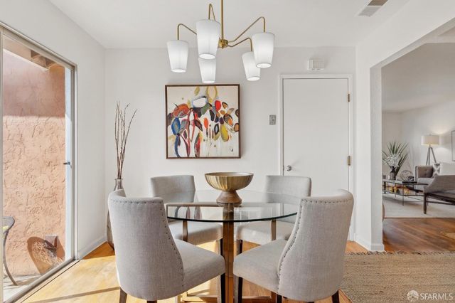 a view of a dining room with furniture wooden floor and a chandelier