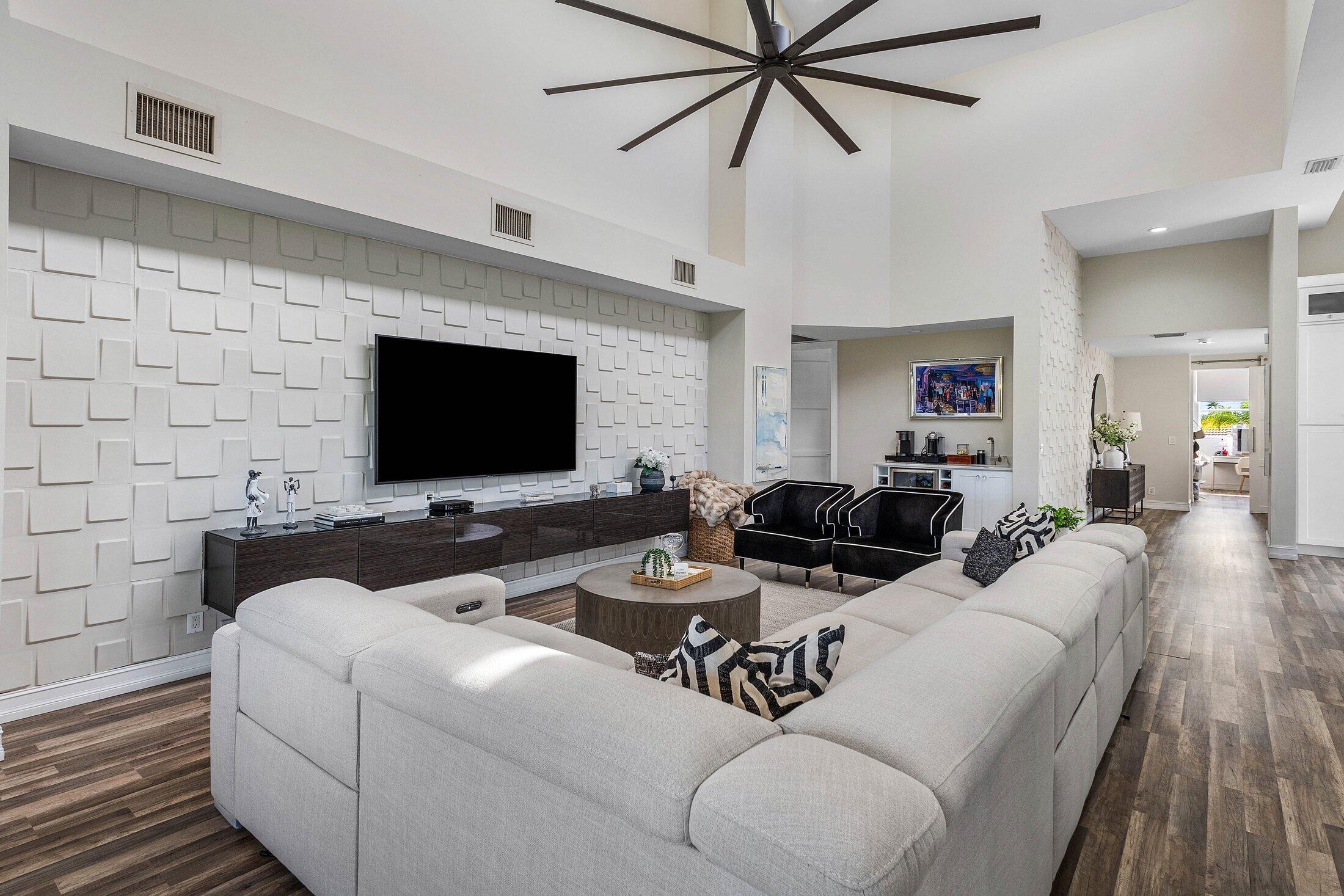 5887 Northwest 24th Avenue, Unit 1203 Boca Raton, FL 33496 - Photo 12 of 62 a living room with furniture and a flat screen tv