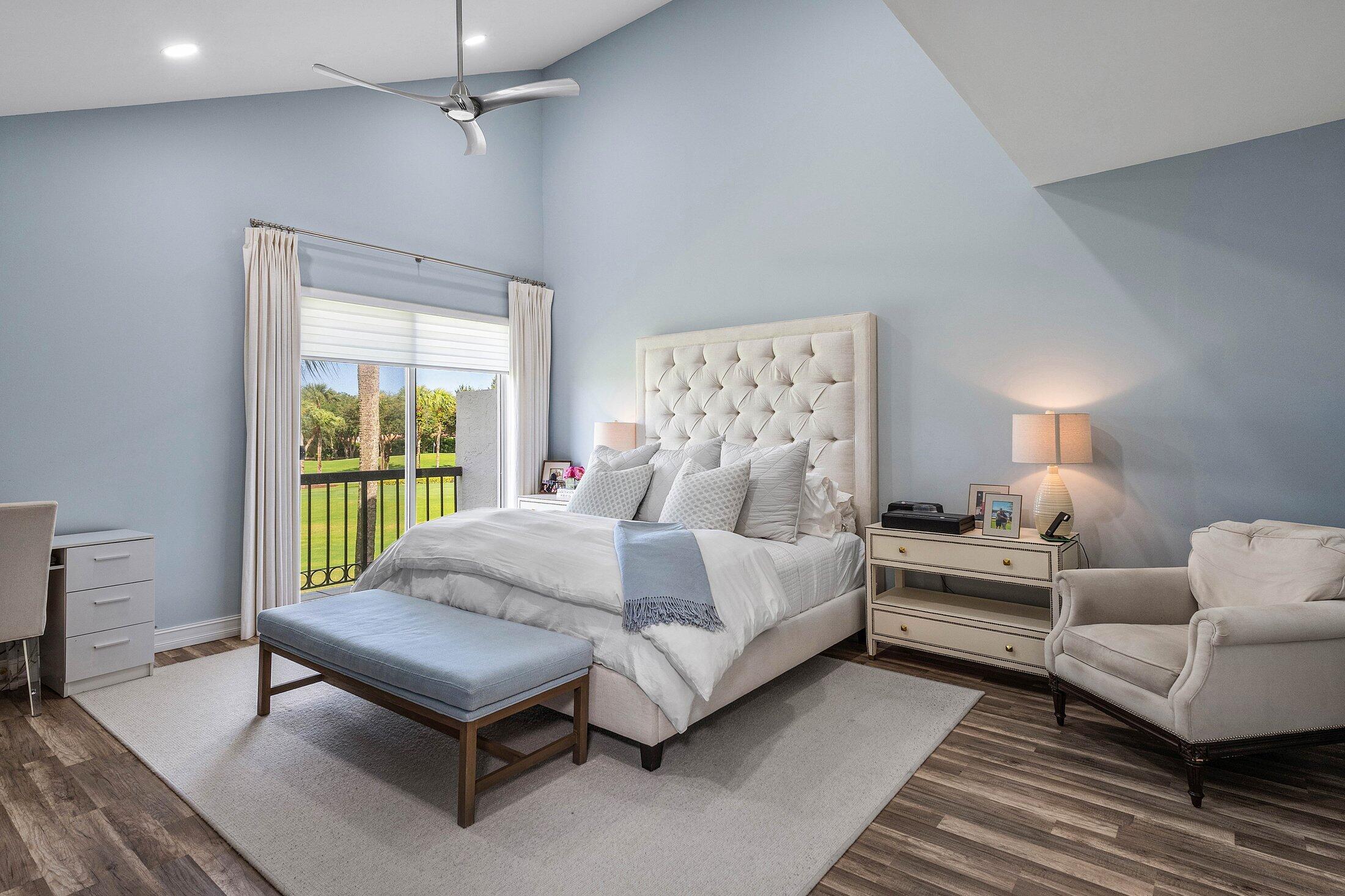 5887 Northwest 24th Avenue, Unit 1203 Boca Raton, FL 33496 - Photo 15 of 62 a bedroom with a bed and wooden floor