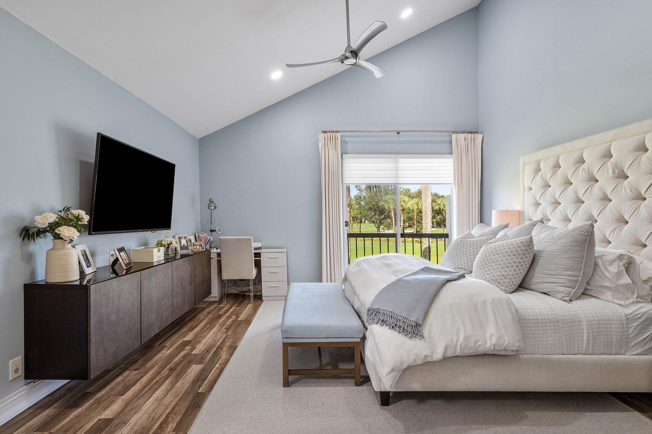 5887 Northwest 24th Avenue, Unit 1203 Boca Raton, FL 33496 - Photo 16 of 62 a bedroom with a bed and a flat screen tv