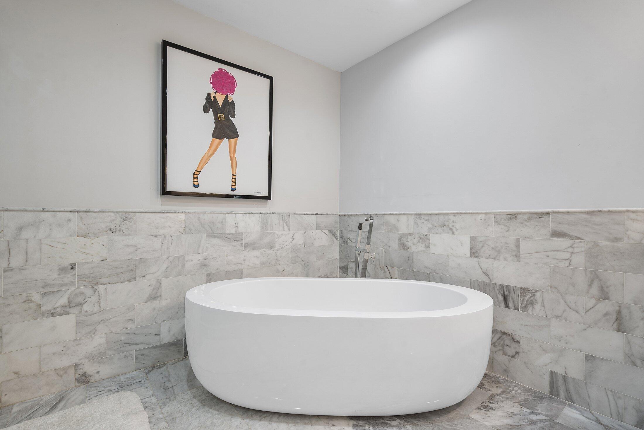 5887 Northwest 24th Avenue, Unit 1203 Boca Raton, FL 33496 - Photo 18 of 62 a white bath tub sitting in a bathroom