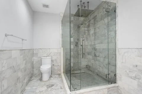 a bedroom with a bed and a night stand