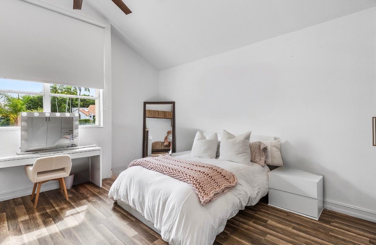 5887 Northwest 24th Avenue, Unit 1203 Boca Raton, FL 33496 - Photo 20 of 62 a bedroom with a bed and a table