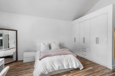 a bedroom with a bed and a chair