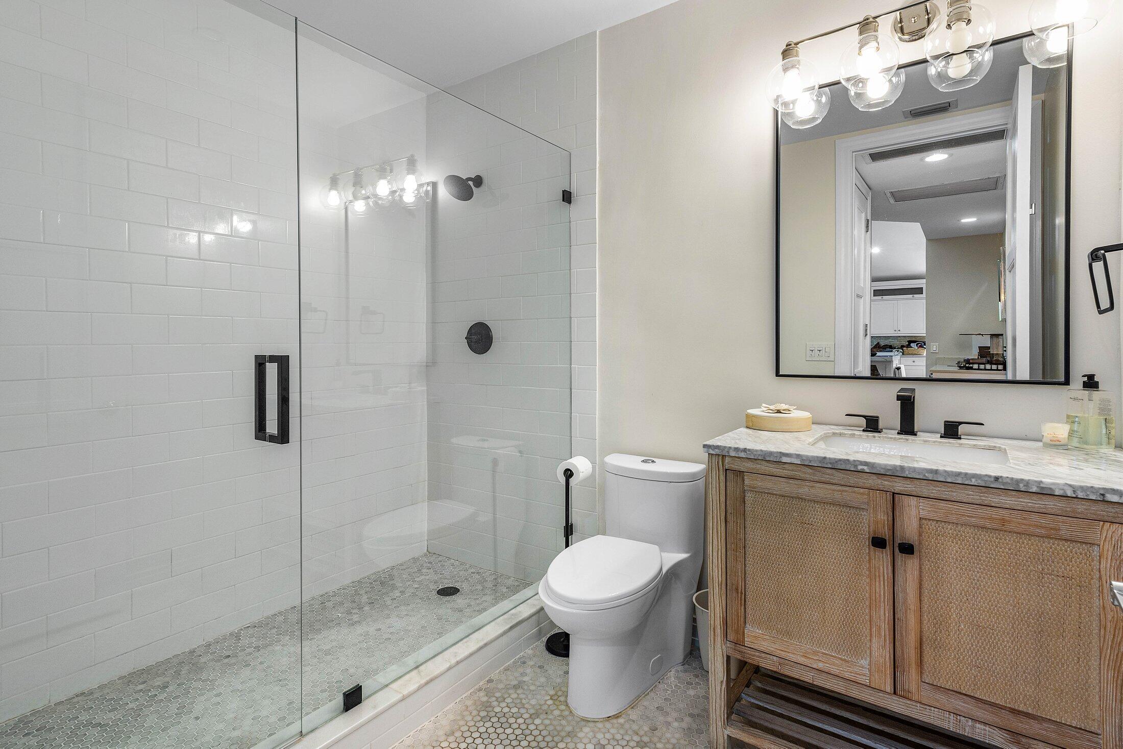 5887 Northwest 24th Avenue, Unit 1203 Boca Raton, FL 33496 - Photo 22 of 62 a bathroom with a toilet sink and shower