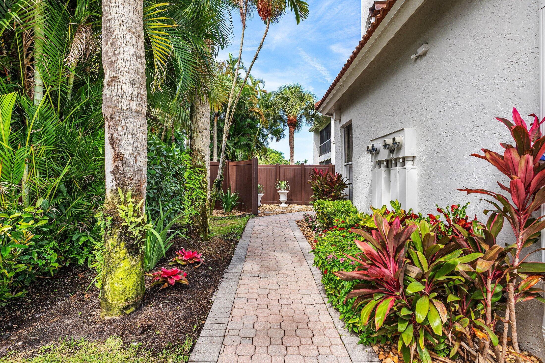 5887 Northwest 24th Avenue, Unit 1203 Boca Raton, FL 33496 - Photo 35 of 62 a view of a pathway with flower plants