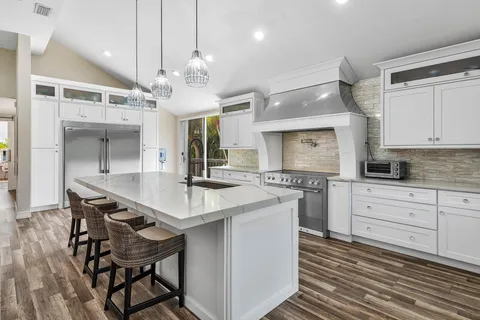 a kitchen with cabinets a sink and appliances