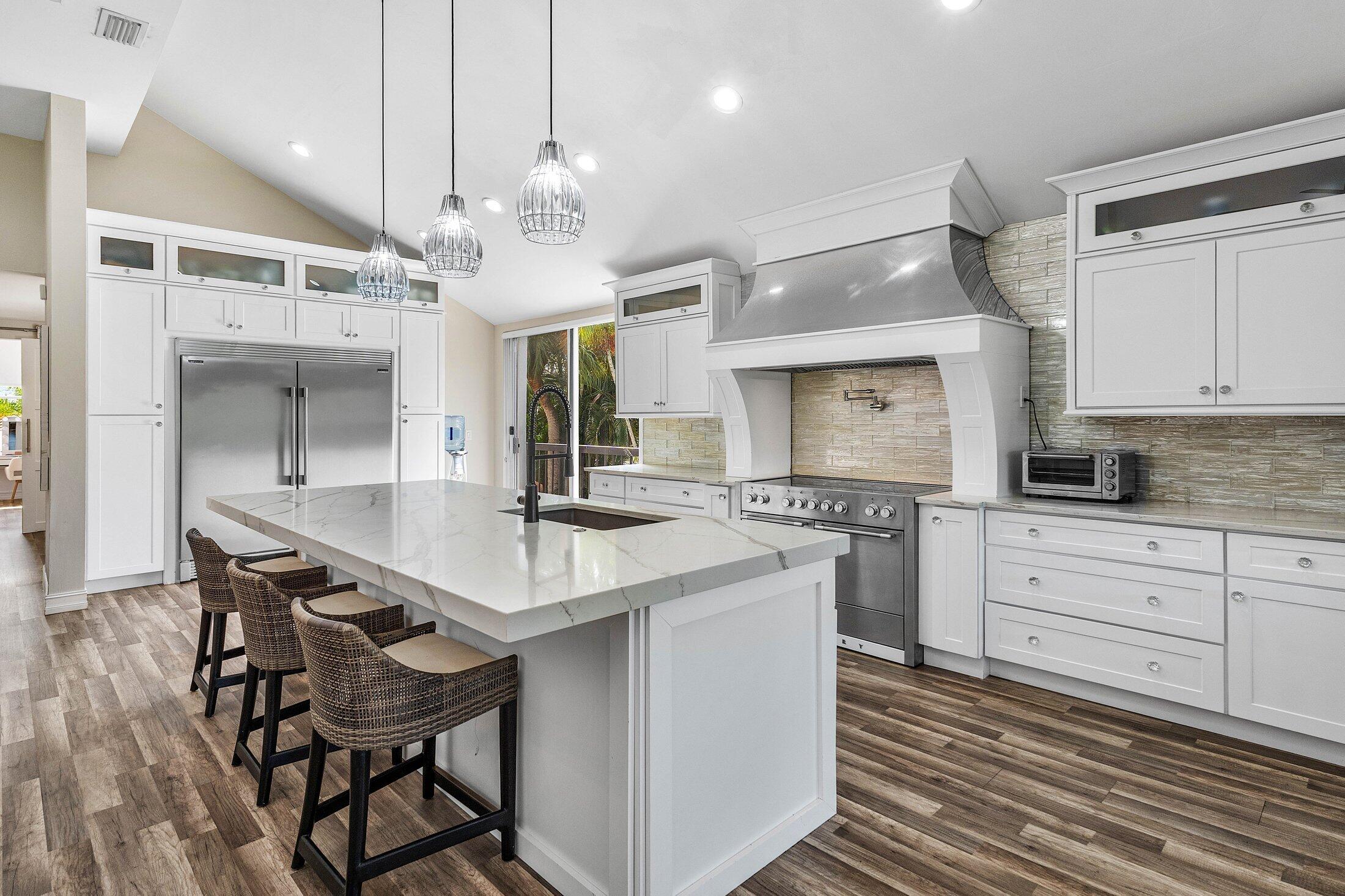 5887 Northwest 24th Avenue, Unit 1203 Boca Raton, FL 33496 - Photo 4 of 62 a kitchen with stainless steel appliances a dining table chairs and stove