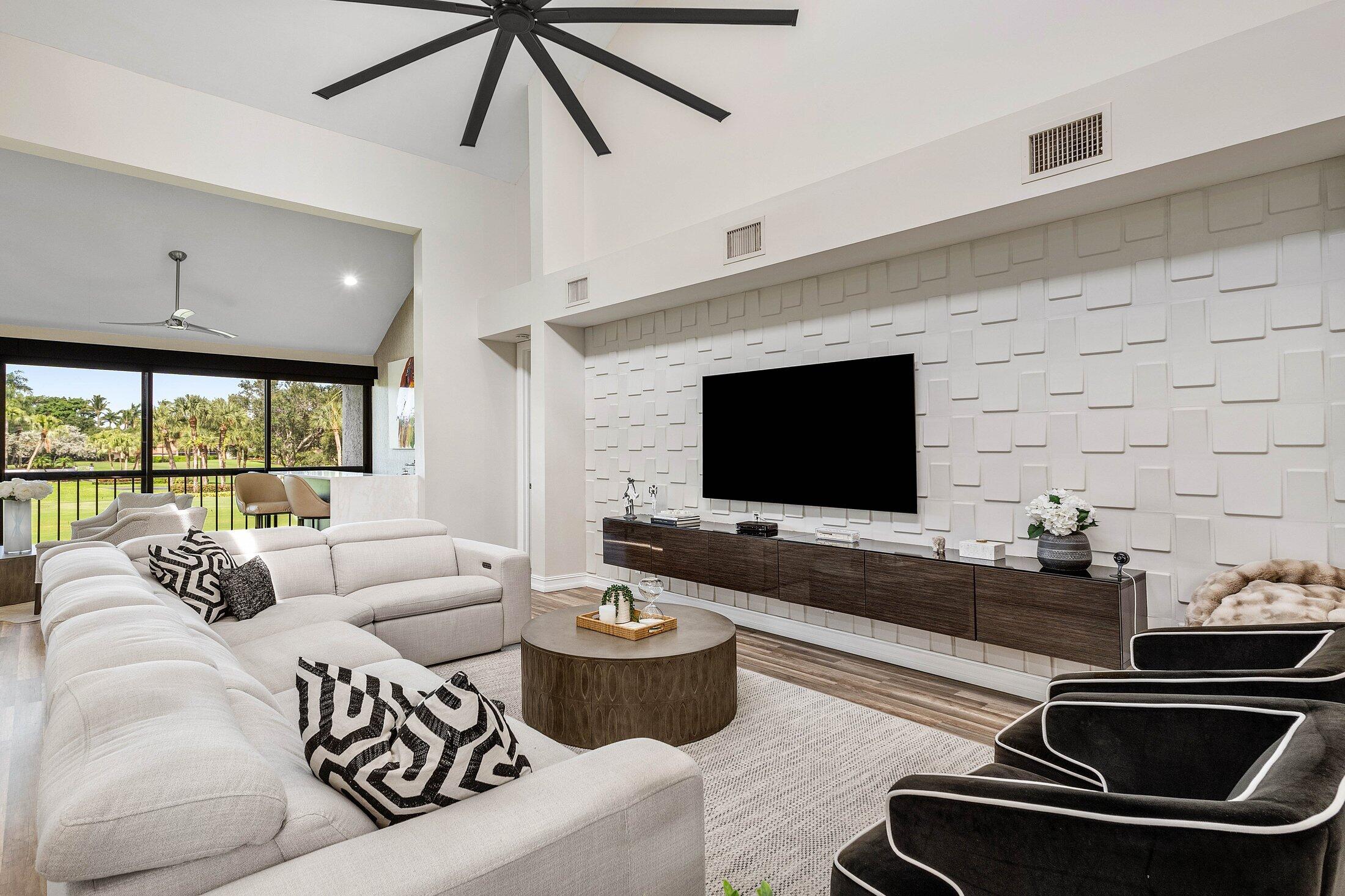5887 Northwest 24th Avenue, Unit 1203 Boca Raton, FL 33496 - Photo 9 of 62 a living room with furniture and a flat screen tv