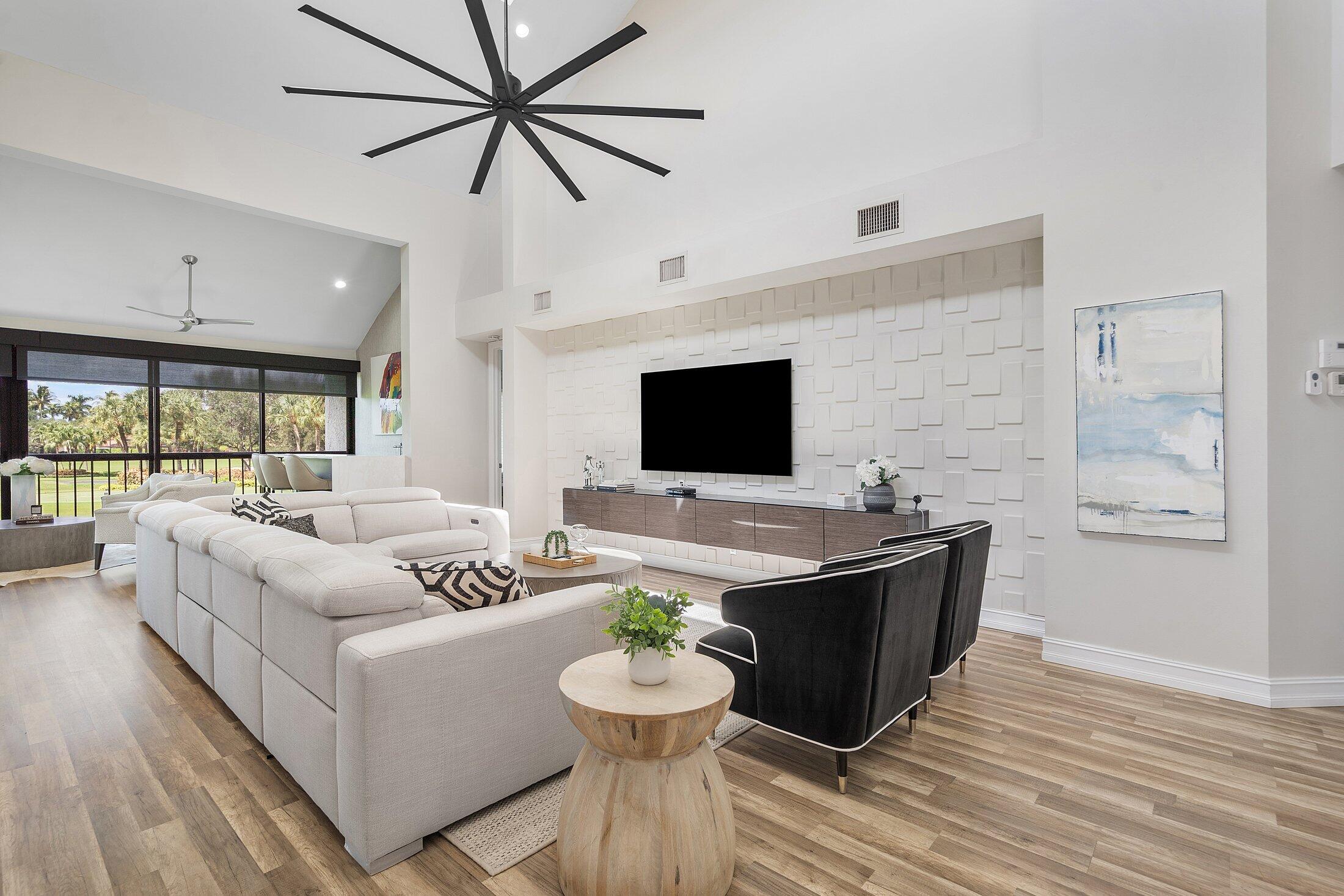 5887 Northwest 24th Avenue, Unit 1203 Boca Raton, FL 33496 - Photo 10 of 62 a living room with furniture and a flat screen tv