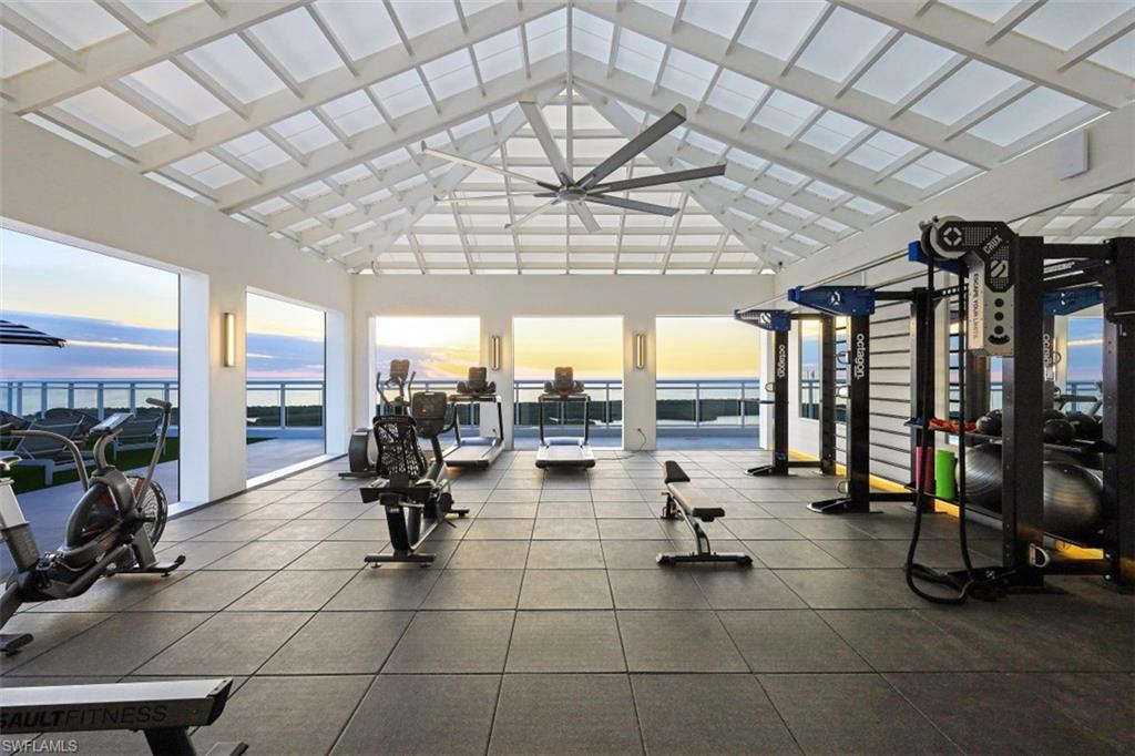 13935 Old Coast Road, Unit 1703 Naples, FL 34110 - Photo 33 of 44 a gym room with lots of furniture and a chandelier