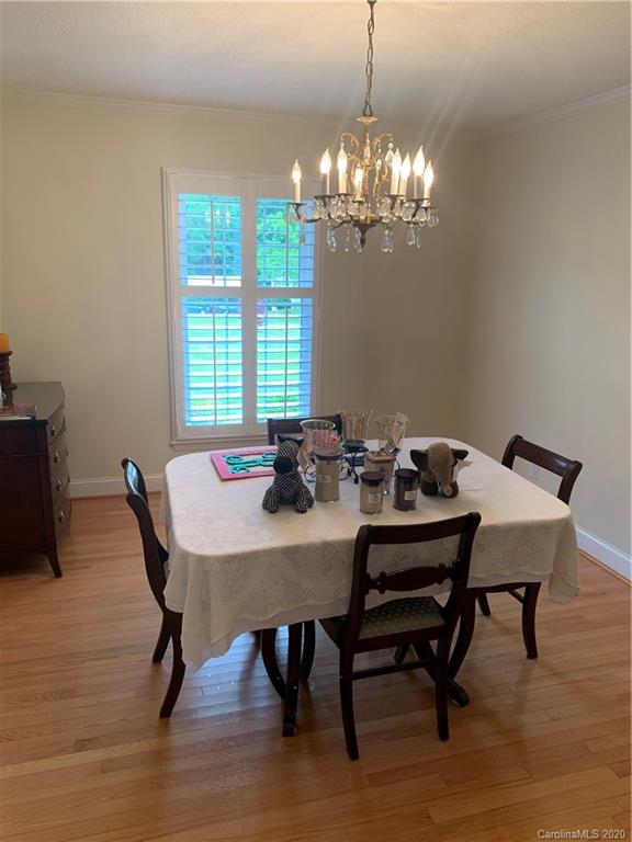 1150 Miles Road Dallas, NC 28034 - Photo 13 of 14 a view of a dining room with furniture a chandelier and wooden floor