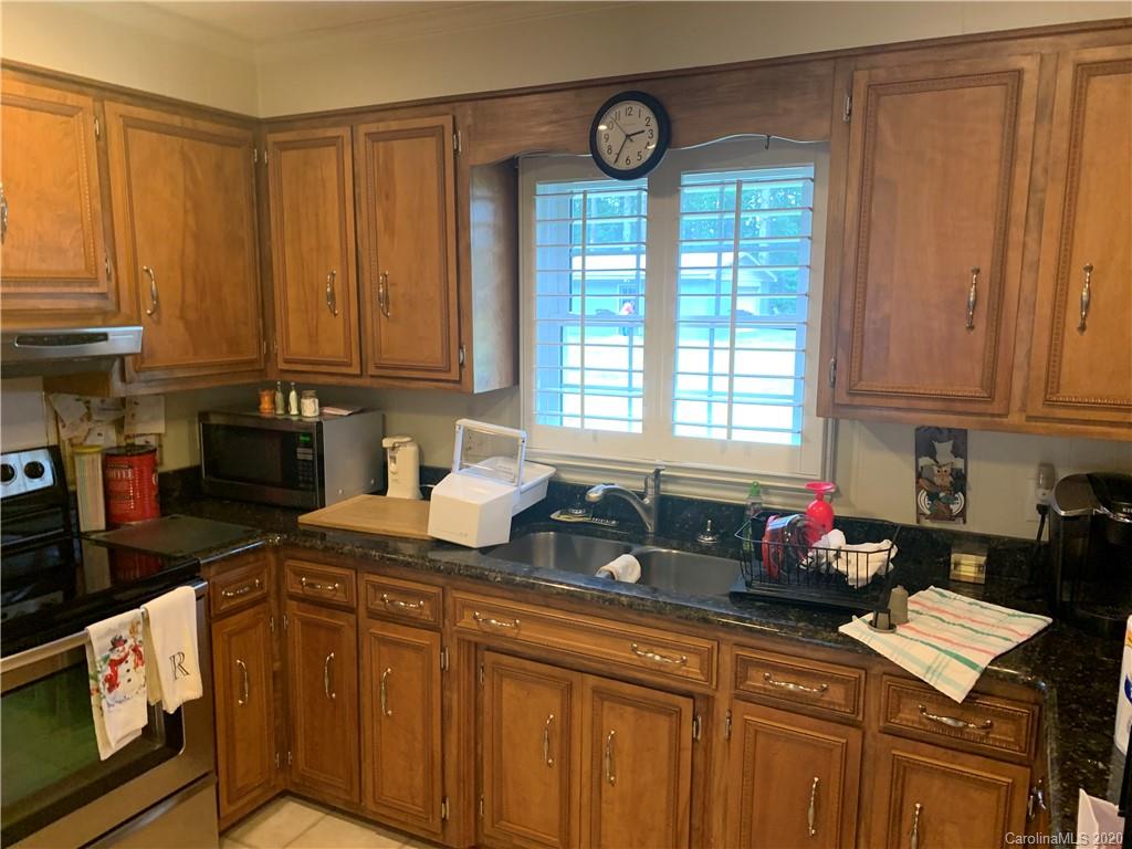 1150 Miles Road Dallas, NC 28034 - Photo 14 of 14 a kitchen with stainless steel appliances granite countertop a stove a sink dishwasher and cabinets with wooden floor
