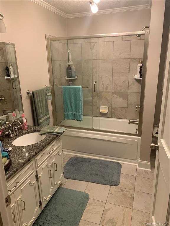 1150 Miles Road Dallas, NC 28034 - Photo 9 of 14 a bathroom with a granite countertop sink a toilet and shower