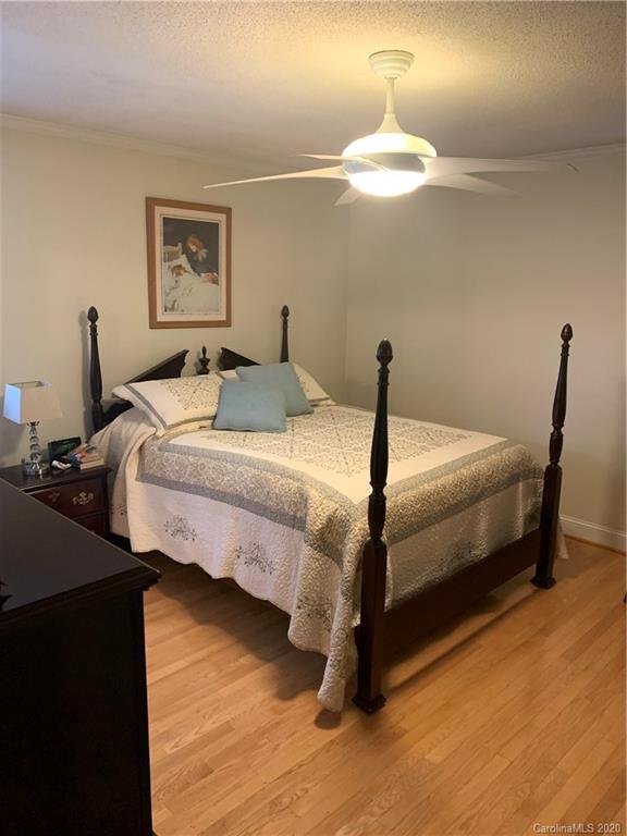 1150 Miles Road Dallas, NC 28034 - Photo 10 of 14 a bedroom with bed and a chandelier