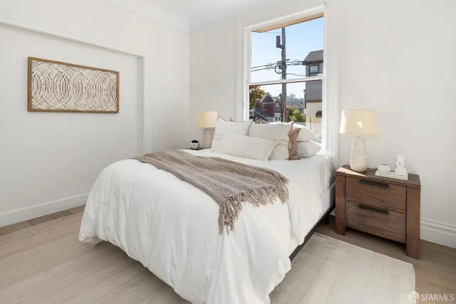 a bedroom with a bed and window