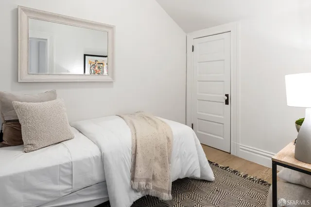 a bedroom with a bed and a lamp