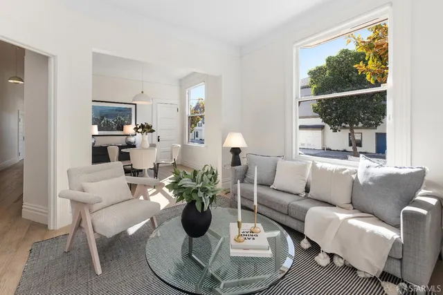a living room with furniture a flat screen tv and a large window