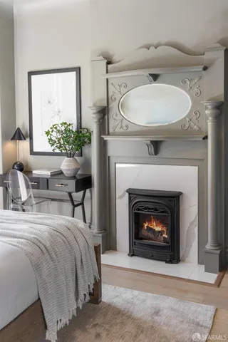 a bedroom with a bed and a fireplace