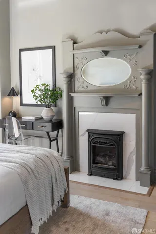 a bedroom with a bed and a fireplace