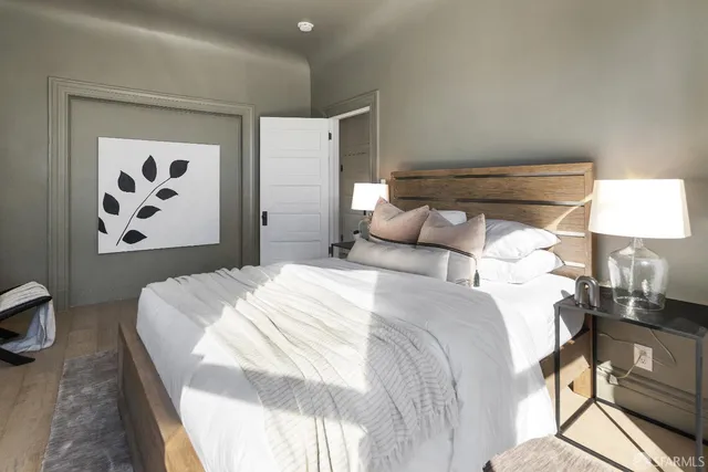 a bedroom with a bed and a painting on the wall