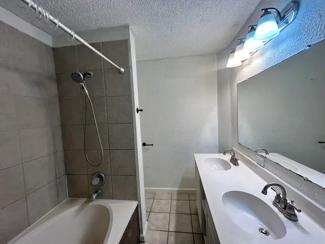 a bathroom with a sink double vanity and tub