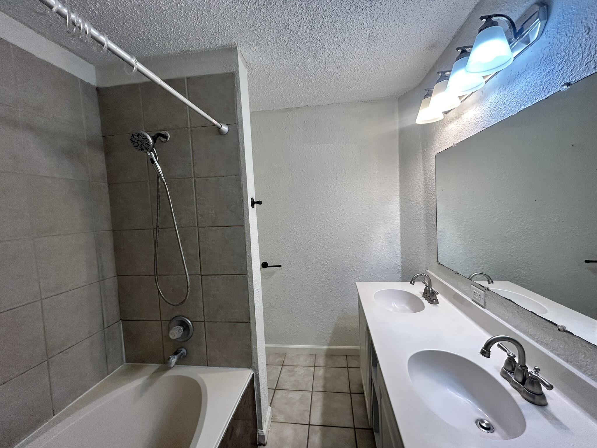 2807 60th Street Lubbock, TX 79413 - Photo 11 of 15 a bathroom with a sink double vanity and tub