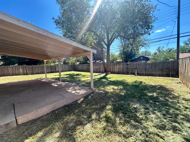 a view of a backyard with swimming pool