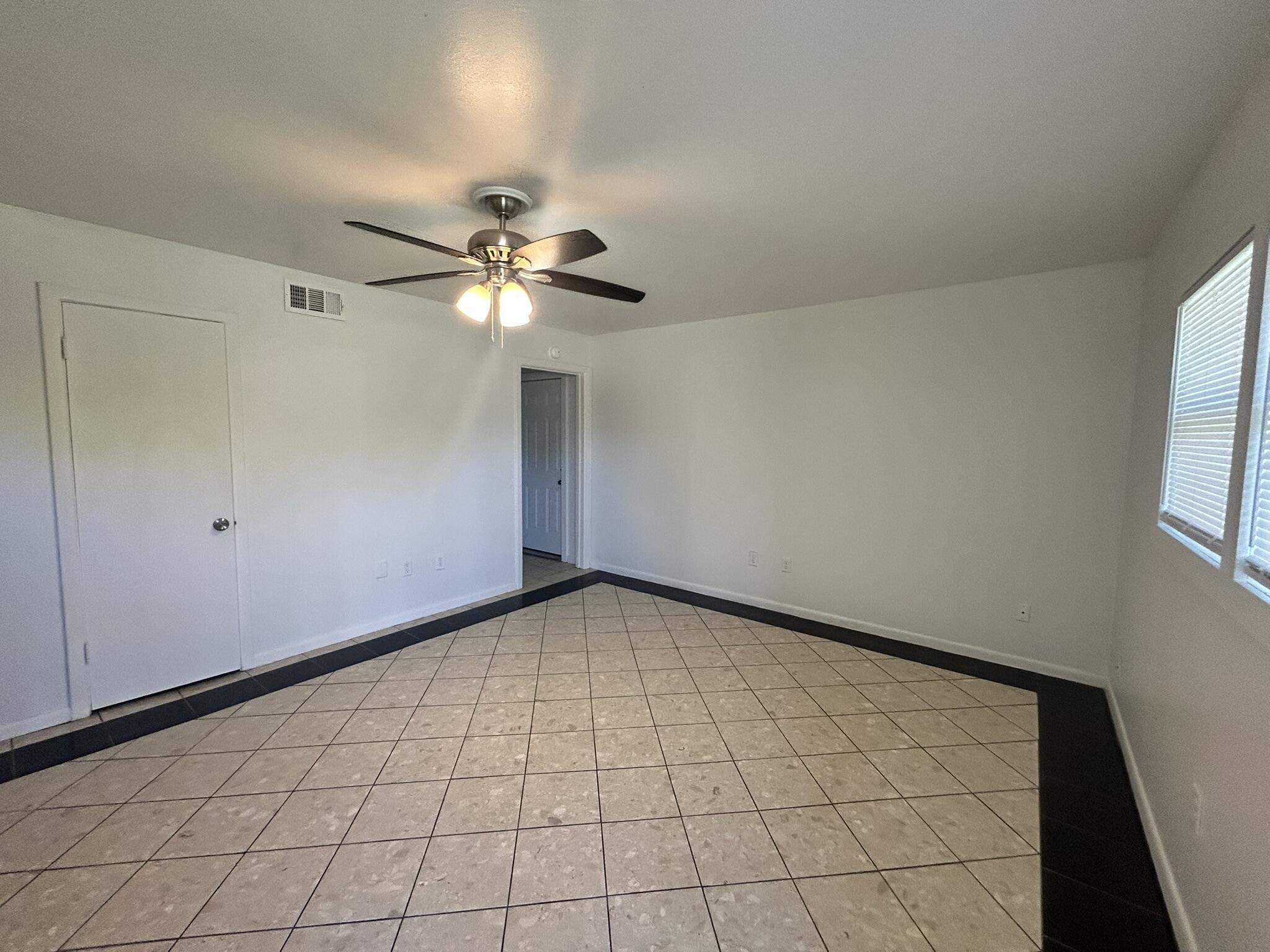 2807 60th Street Lubbock, TX 79413 - Photo 2 of 15 a view of an empty room and chandelier fan