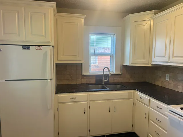 a white refrigerator freezer sitting inside of a kitchen