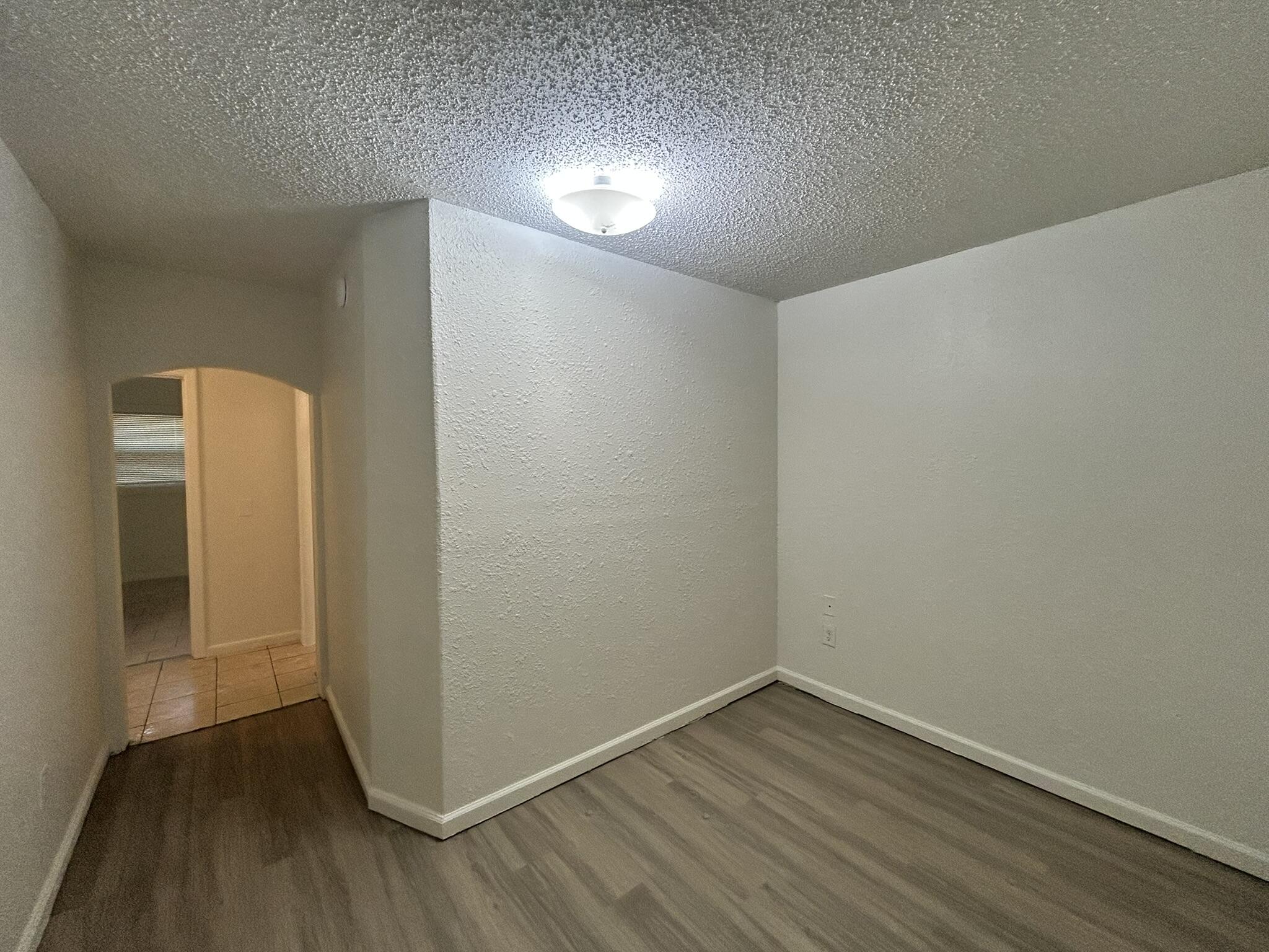 2807 60th Street Lubbock, TX 79413 - Photo 9 of 15 a view of an empty room with wooden floor