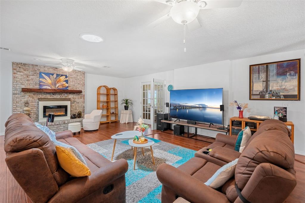 1702 Elaine Avenue Altamonte Springs, FL 32701 - Photo 12 of 39 a living room with furniture a fireplace and a flat screen tv