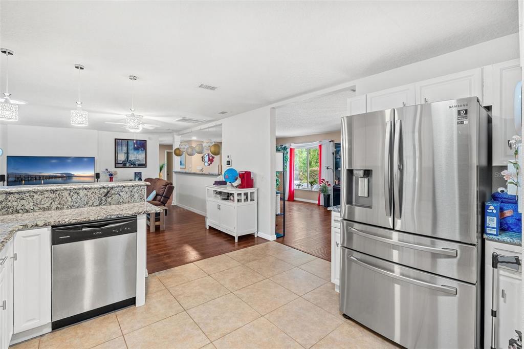 1702 Elaine Avenue Altamonte Springs, FL 32701 - Photo 19 of 39 a kitchen with stainless steel appliances granite countertop a refrigerator and a stove top oven