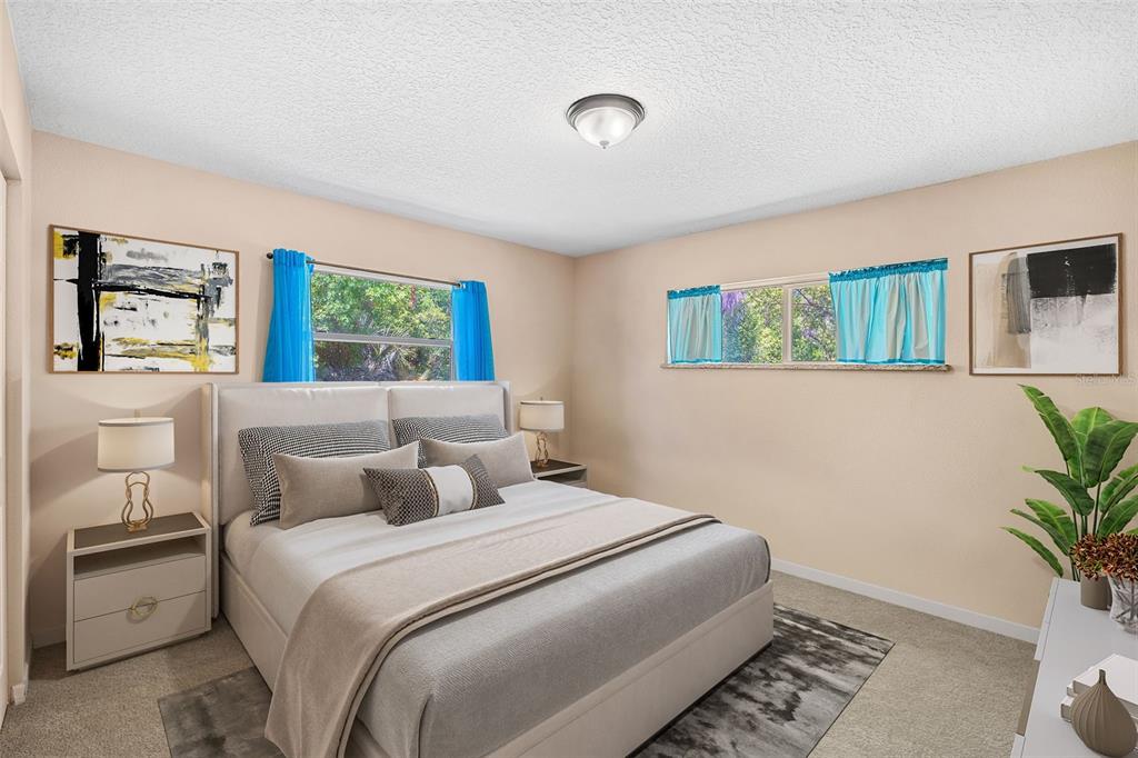 1702 Elaine Avenue Altamonte Springs, FL 32701 - Photo 25 of 39 a bedroom with a large bed and a potted plant