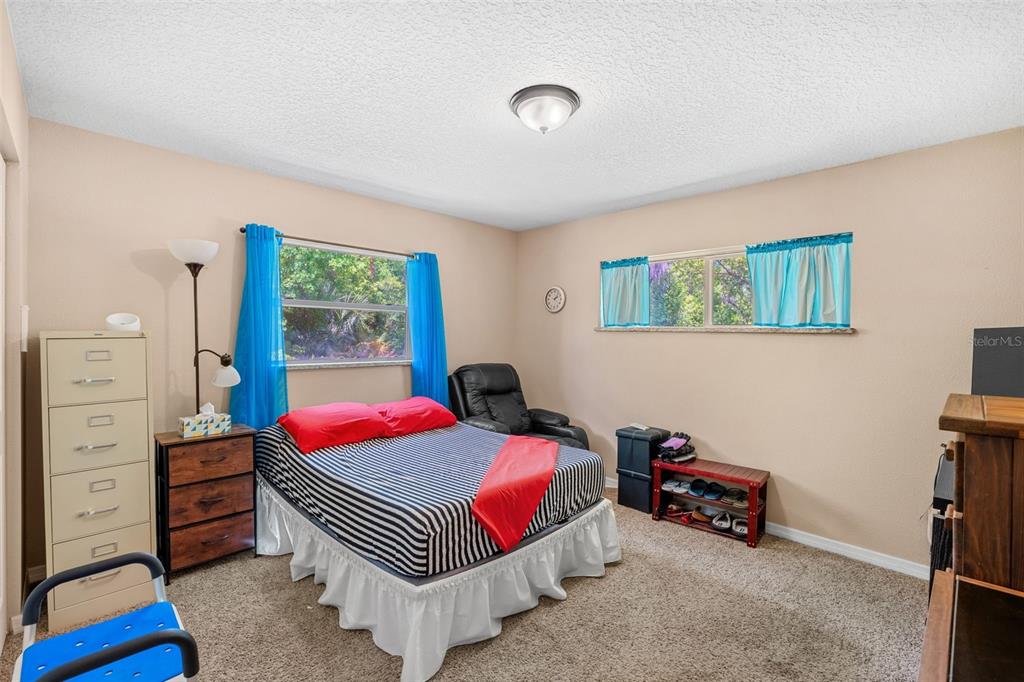 1702 Elaine Avenue Altamonte Springs, FL 32701 - Photo 26 of 39 a bedroom with furniture and a floor to ceiling window