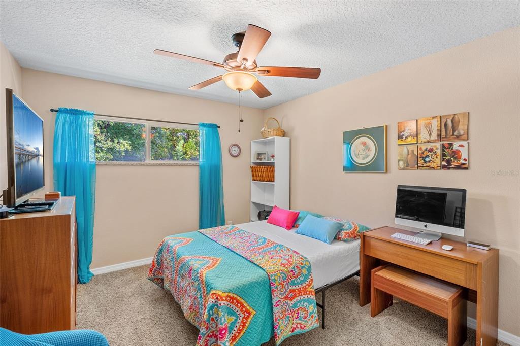 1702 Elaine Avenue Altamonte Springs, FL 32701 - Photo 27 of 39 a bedroom with a bed and a flat screen tv