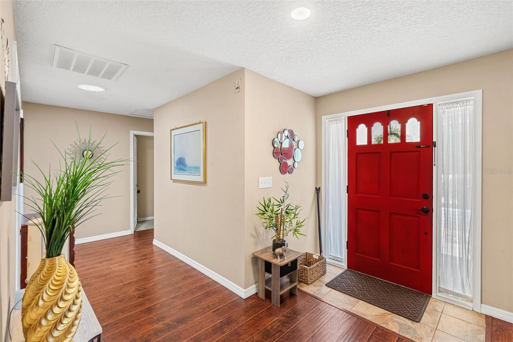 1702 Elaine Avenue Altamonte Springs, FL 32701 - Photo 3 of 39 a living room with furniture bookshelf and wooden floor