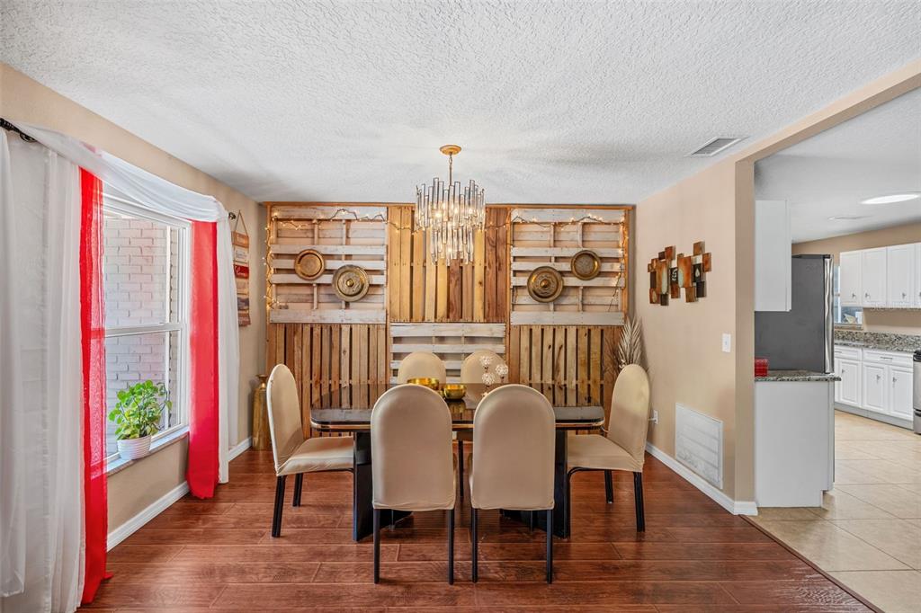 1702 Elaine Avenue Altamonte Springs, FL 32701 - Photo 8 of 39 a view of a dining room with furniture window and wooden floor