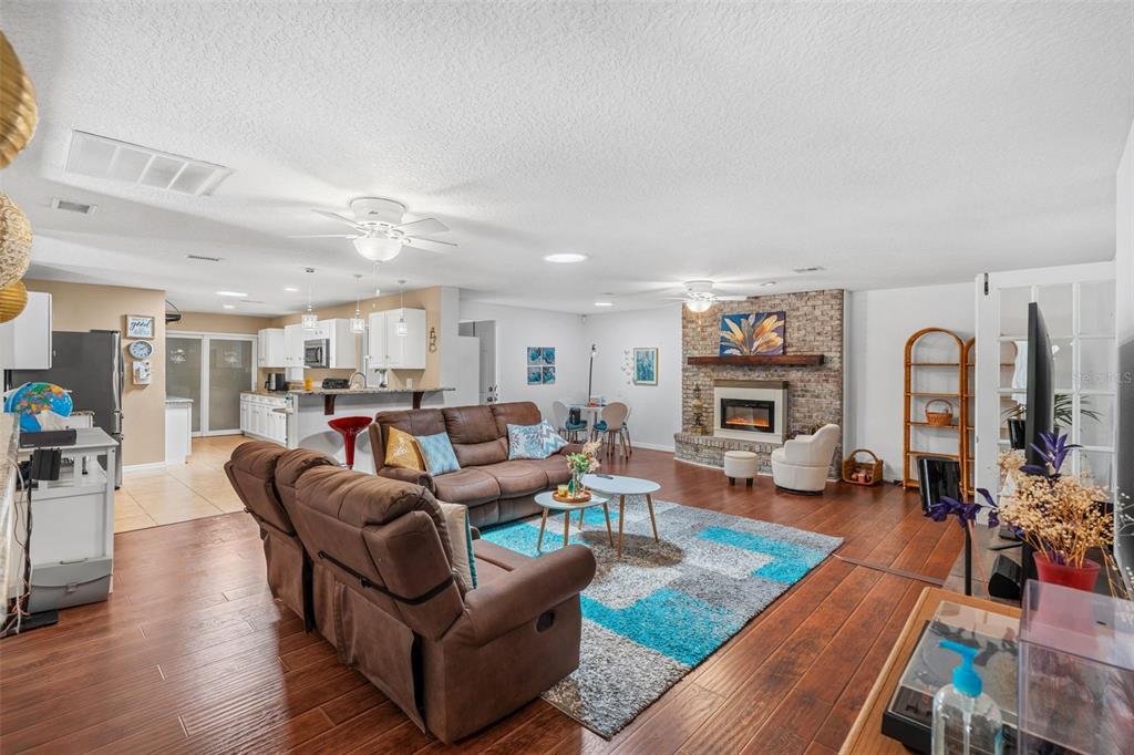 1702 Elaine Avenue Altamonte Springs, FL 32701 - Photo 10 of 39 a living room with fireplace furniture and a wooden floor