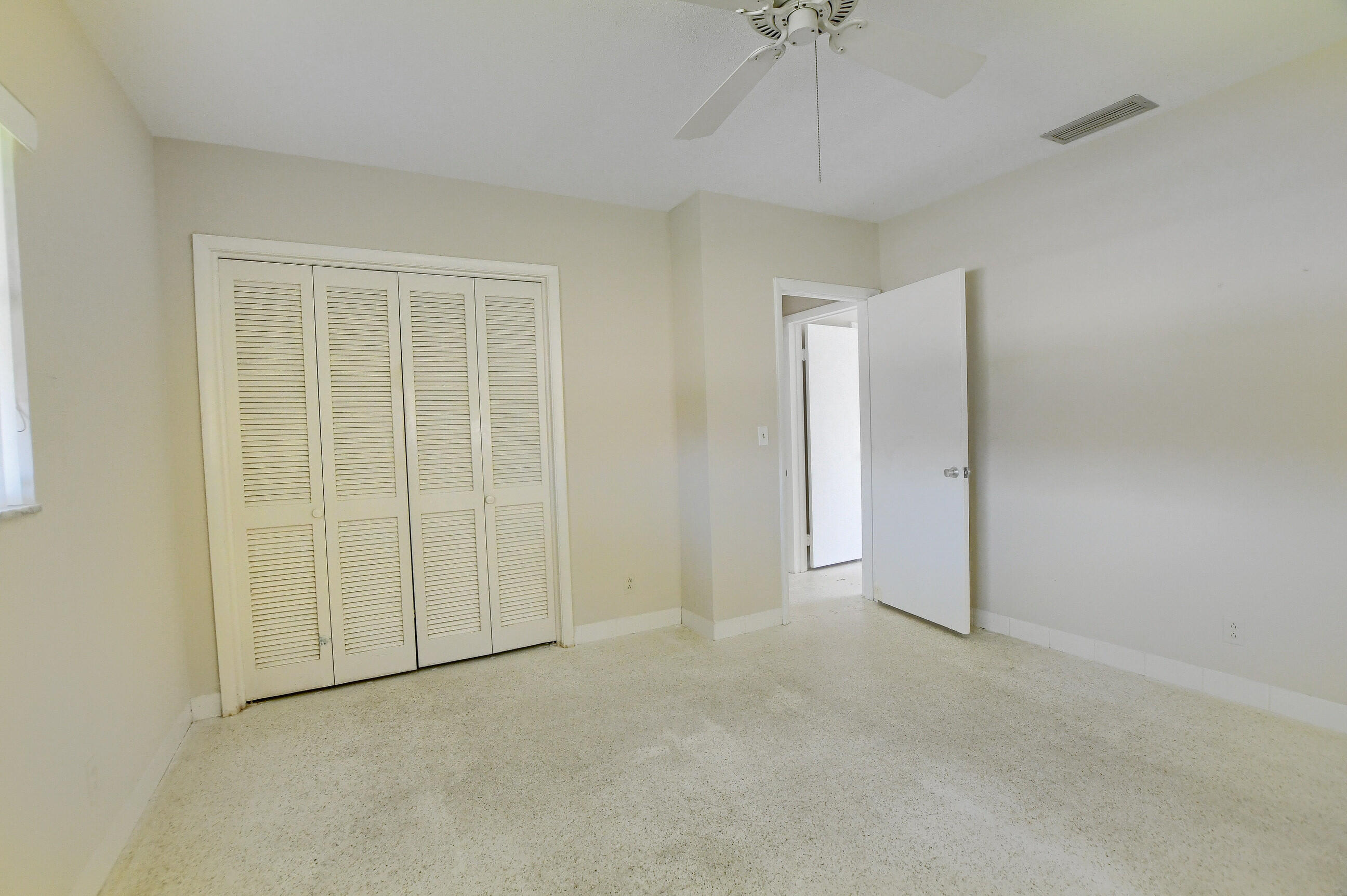 1099 Southwest 13th Place Boca Raton, FL 33486 - Photo 24 of 45 a view of an empty room and a chandelier fan