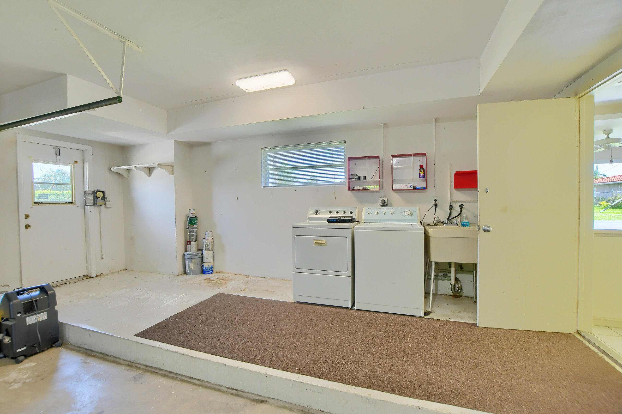 1099 Southwest 13th Place Boca Raton, FL 33486 - Photo 30 of 45 a utility room with cabinets washer and dryer