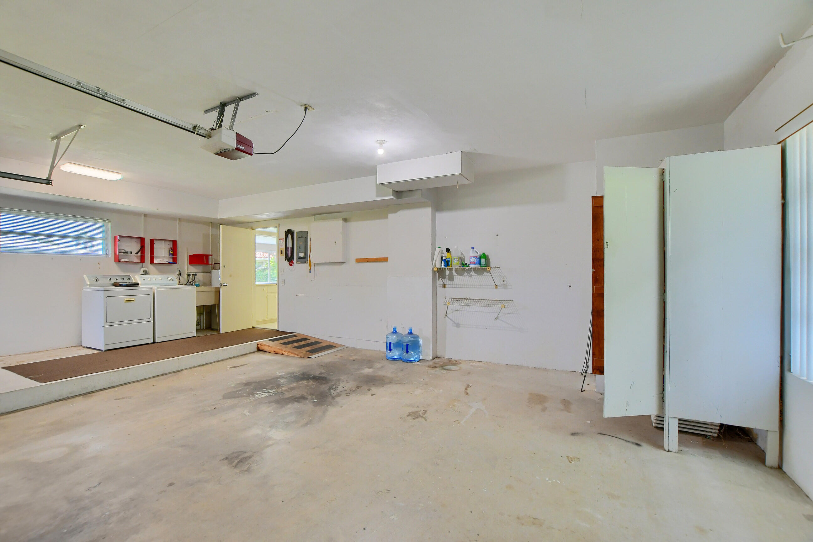 1099 Southwest 13th Place Boca Raton, FL 33486 - Photo 31 of 45 a view of a kitchen with a refrigerator and a ceiling fan
