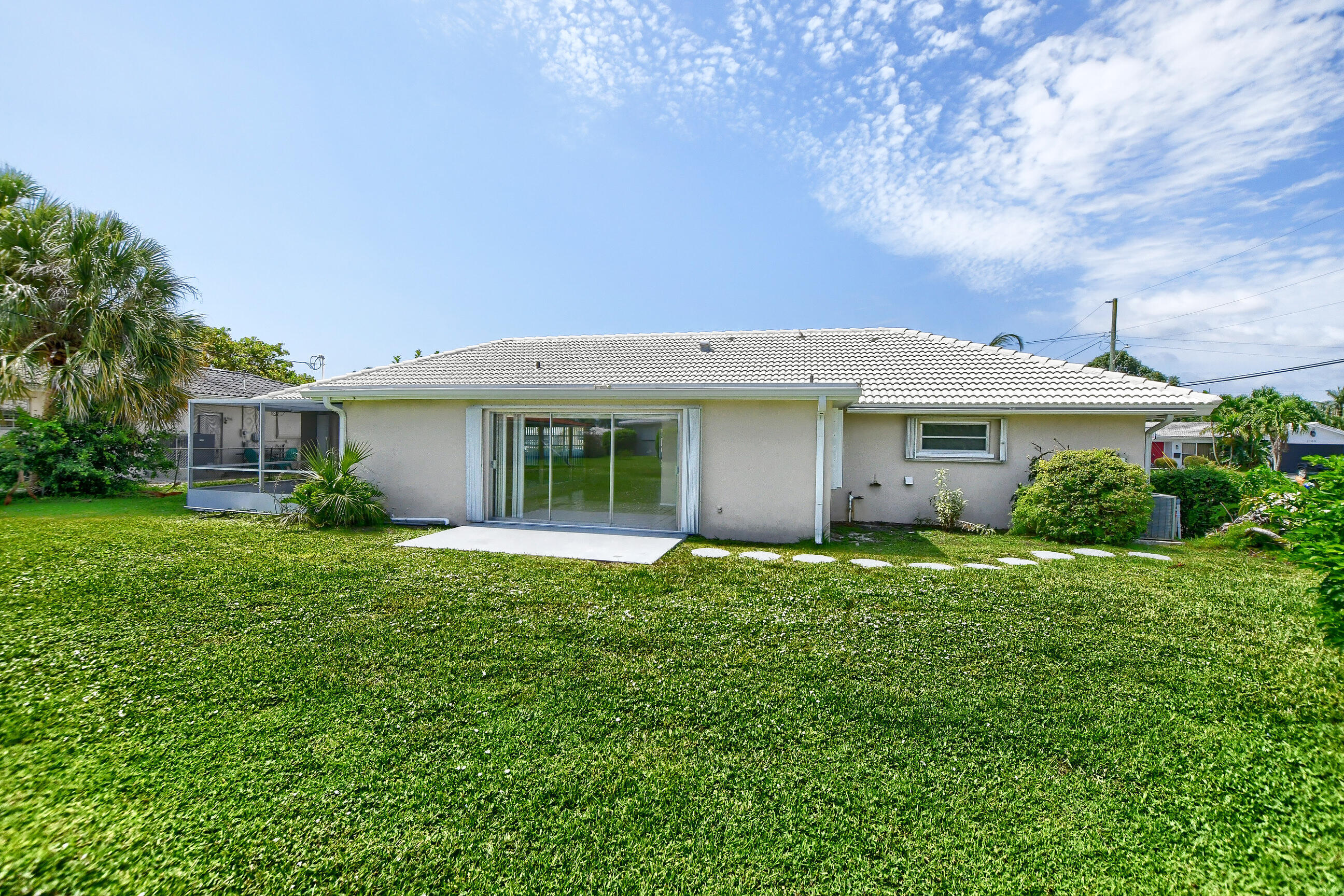 1099 Southwest 13th Place Boca Raton, FL 33486 - Photo 6 of 45 front view of a house with a garden