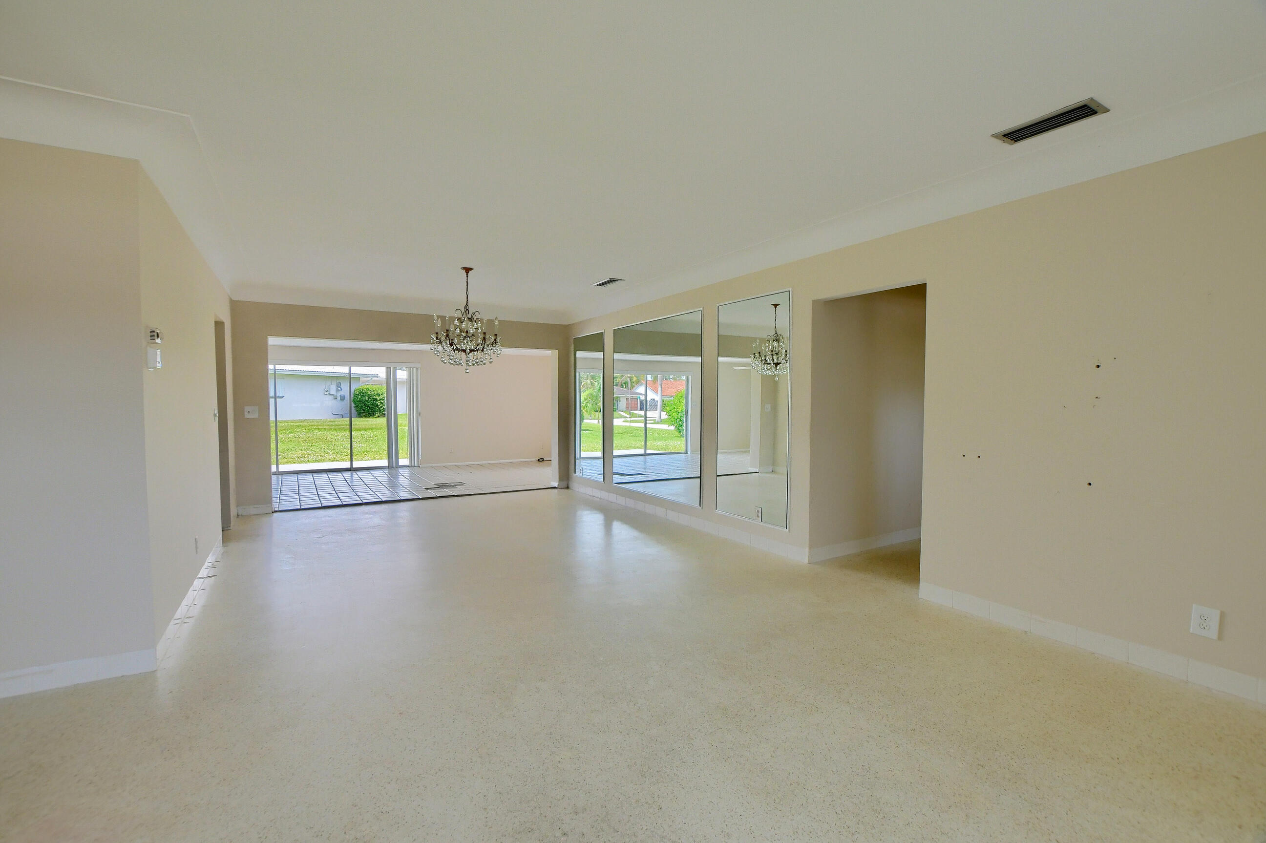 1099 Southwest 13th Place Boca Raton, FL 33486 - Photo 9 of 45 a view of an empty room with window and a kitchen view