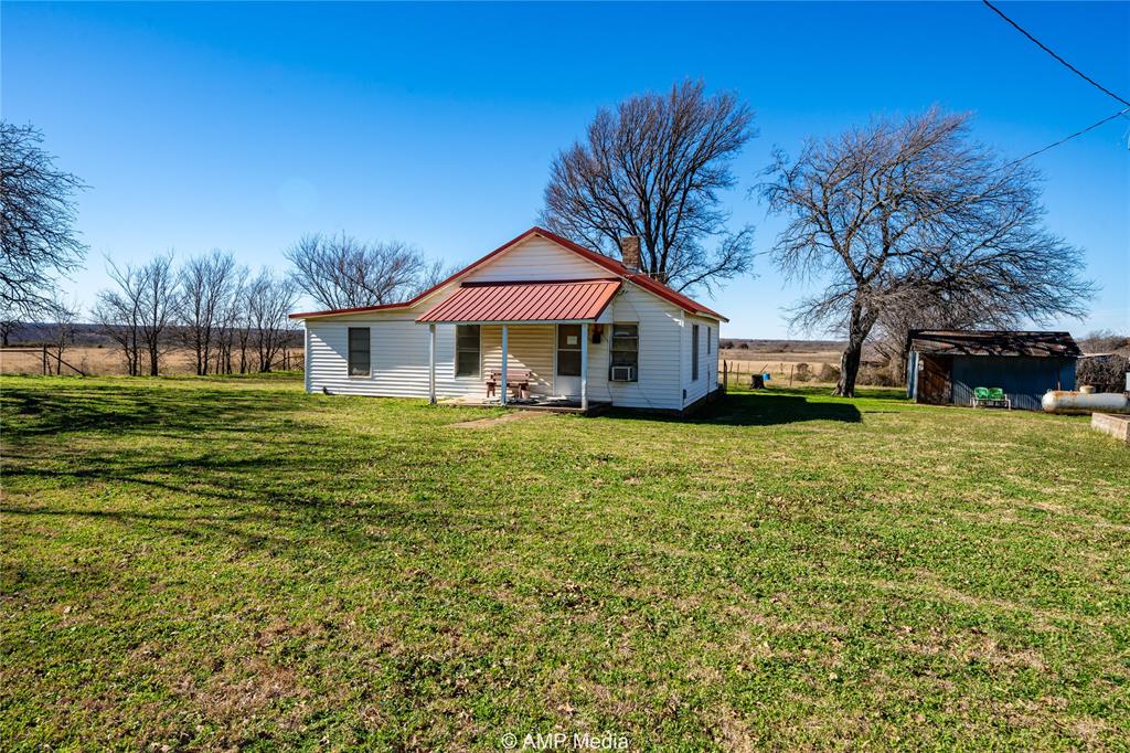 1992 Sand Flat Road Jacksboro, TX 76458 - Photo 15 of 36 Back of house with covered porch and a lawn