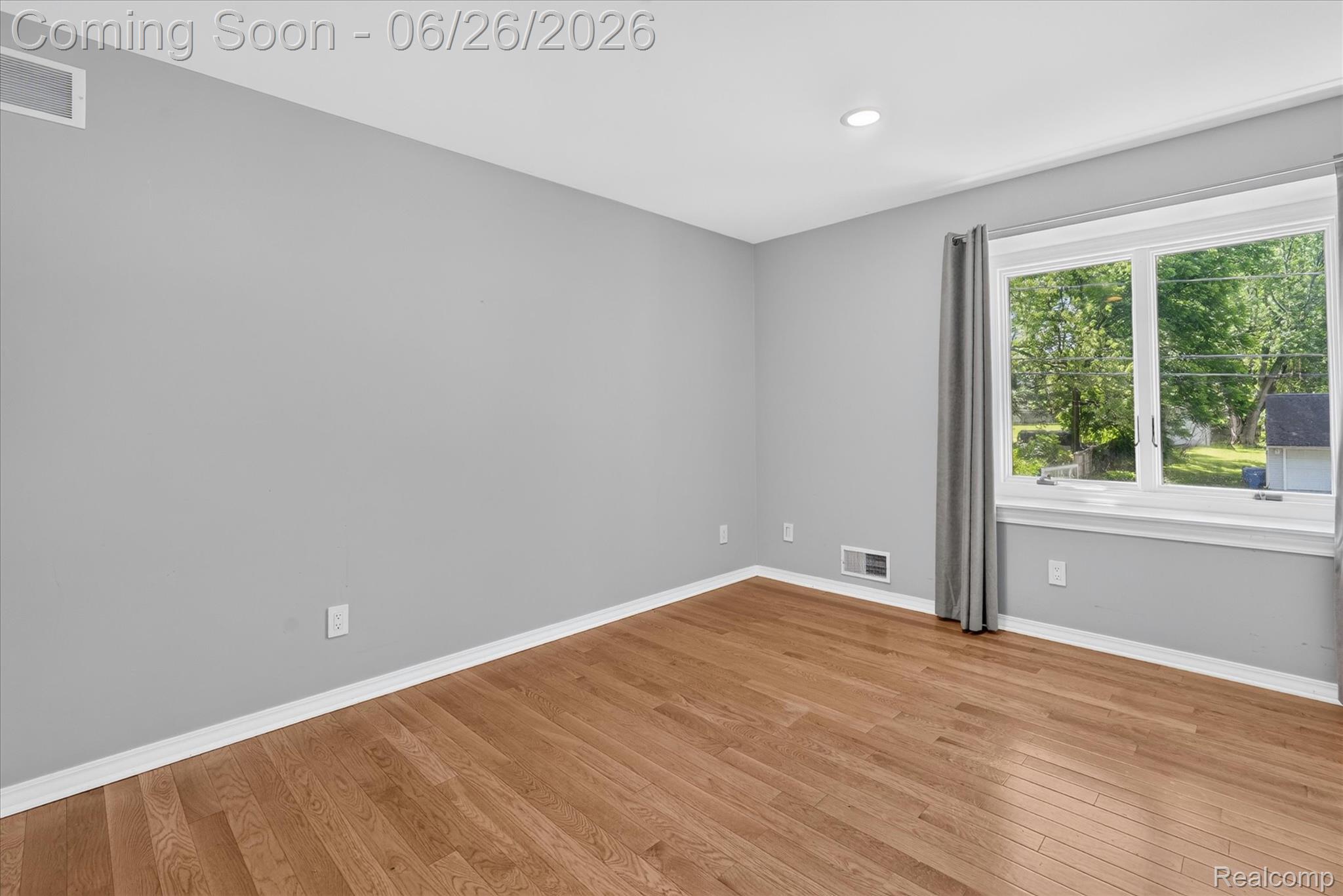 3478 Lexington Road Waterford, MI 48328 - Photo 20 of 52 Room featuring light gray walls, wood-finish flooring, white trim, and a window with white framing