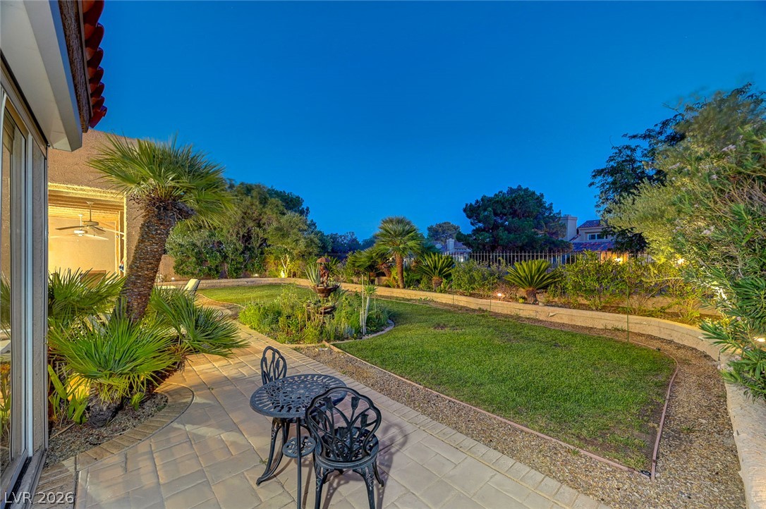 7995 Rio Rico Drive Las Vegas, NV 89113 - Photo 68 of 92 An inviting backyard oasis offers a serene paved patio and lush garden landscaping.