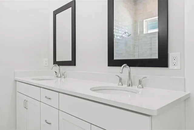 a bathroom with 2 sink and a mirror